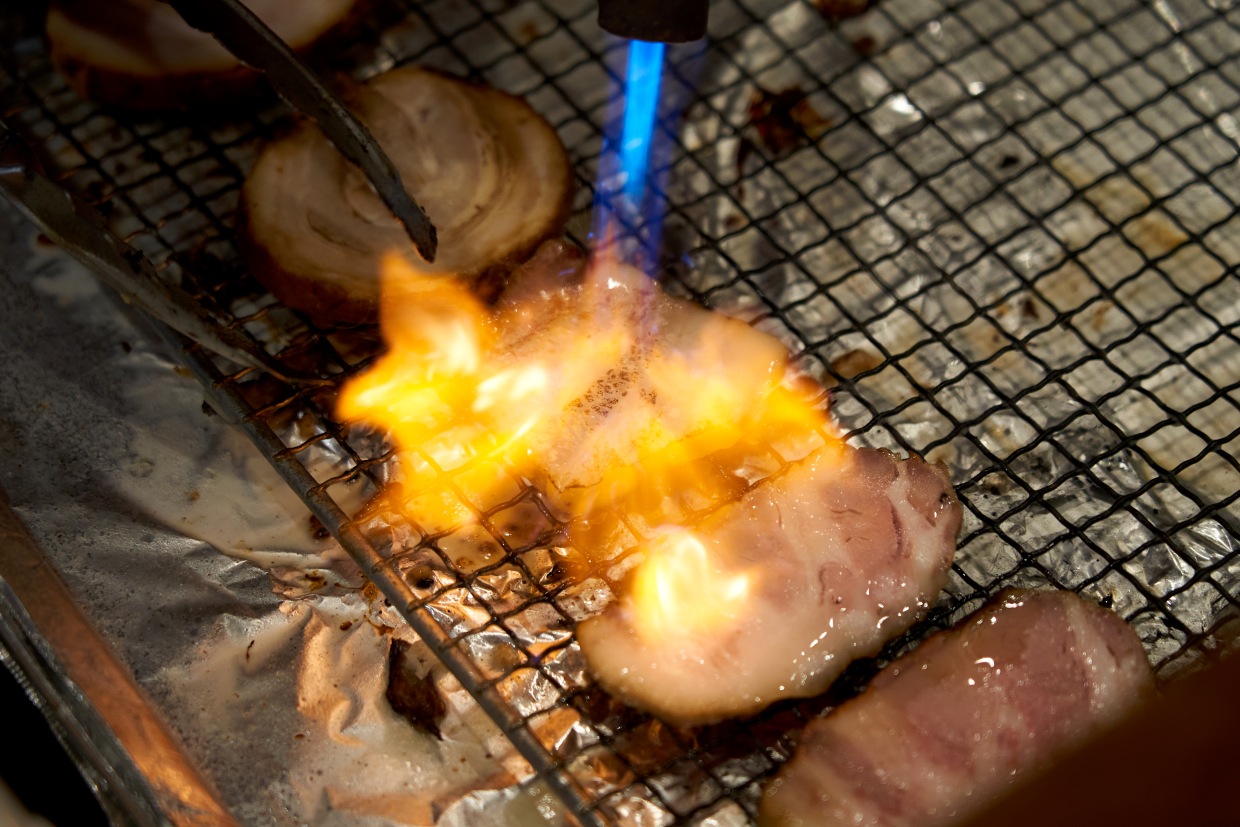 『江戸堀 焼豚食堂』焼豚をバーナーで炙る様子